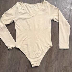 Women's shapewear compression cream bodysuit with long sleeves Size: M
